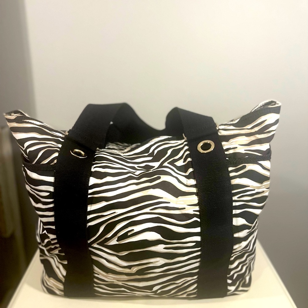 Express zebra print tote bag. Color Black/White/Tan. Double canvas handles.